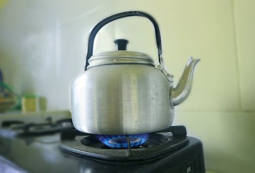 Old aluminum kettle boiling Vintage on the stove photo