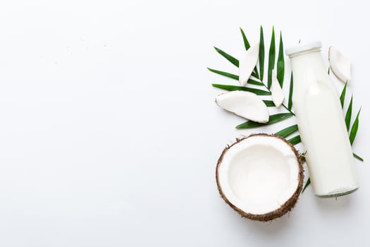coconut products on white background. Dairy free milk substitute drink photo