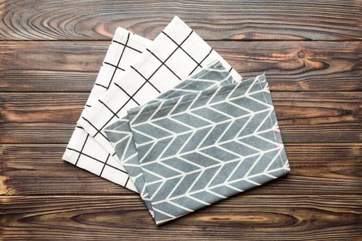 top view with blue kitchen napkin isolated on table background. Folded cloth photo