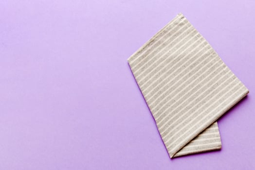 top view with gray kitchen napkin isolated on table background. Folded cloth mockup with copy space, photo