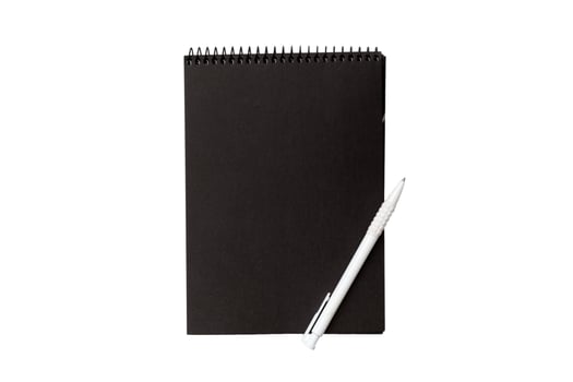 Top view closed spiral blank dark paper cover notebook with pencil isolated on white background photo
