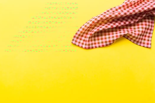 top view with red empty kitchen napkin isolated on table background. Folded cloth with copy space photo