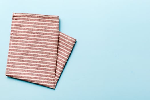 top view red empty napkin isolated on table background. Folded cloth for mockup photo
