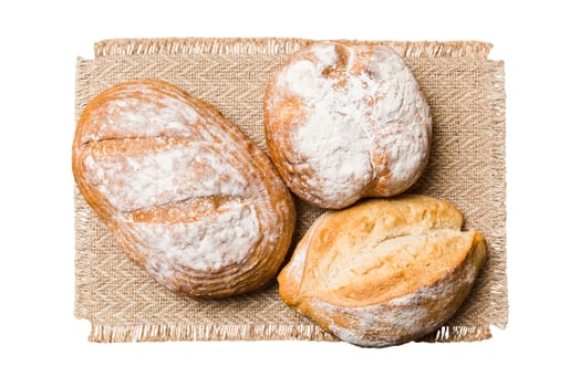 Freshly baked delicious french bread napkin isolated on white background. Healthy bread loaf photo
