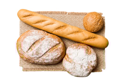 Freshly baked delicious french bread with napkin isolated white background Healthy white bread loaf photo