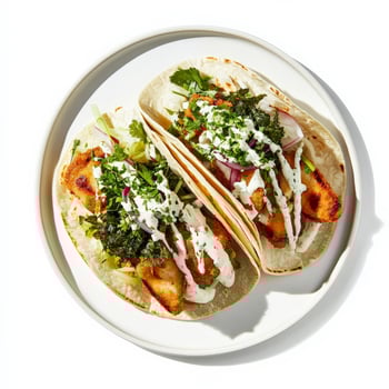 A plate of Mexican street food, reinterpreted with the fresh and delicate flavours of Japanese cuisine, featuring grilled fish tacos, topped with seaweed salad, pickled daikon, and a wasabi crema, a light and healthy take on a Mexican favorite, isolated o photo