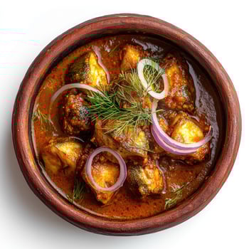 Delicious fish curry dish served in a traditional clay pot bowl photo