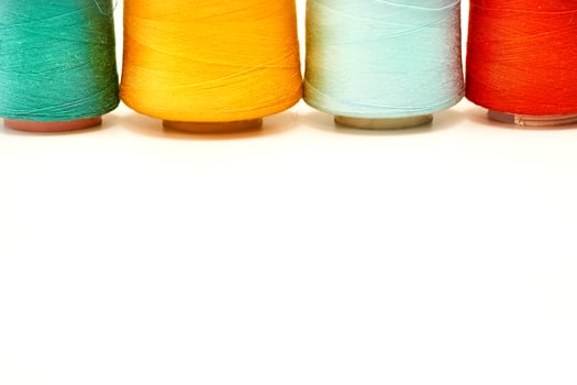 Four colored spools of thread.Tailoring supplies photo
