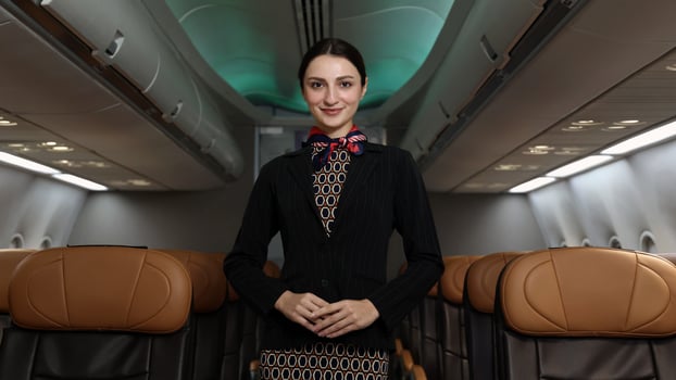 Friendly flight ,attendant stand confidently inside an airplane cabin. photo
