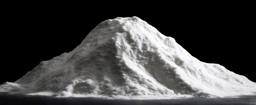 The mound of finely powdered white substance against a dark background photo