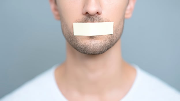 Man with tape over his mouth photo