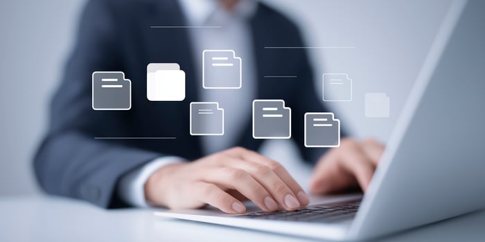 Business professional working on laptop with digital file icons floating above in modern office environment showcasing technology and productivity concepts photo