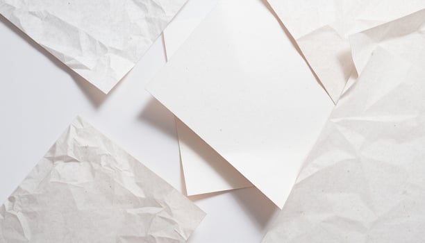 White paper crumpled on a white surface photo