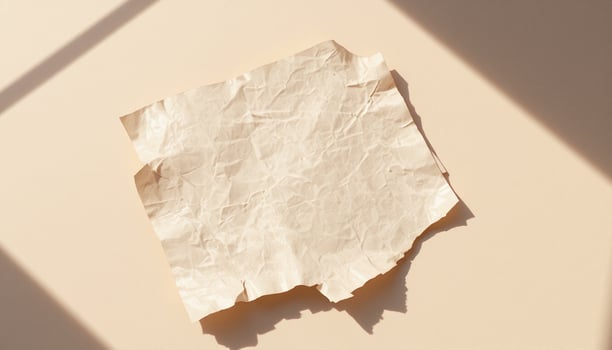 A piece of paper on a wall with a shadow photo
