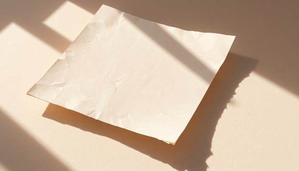 A piece of paper on a table with sunlight photo