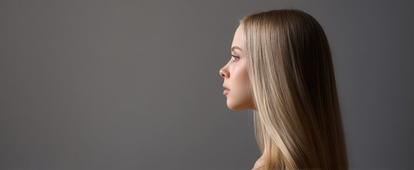 The profile of a beautiful young woman with long blonde hair. photo