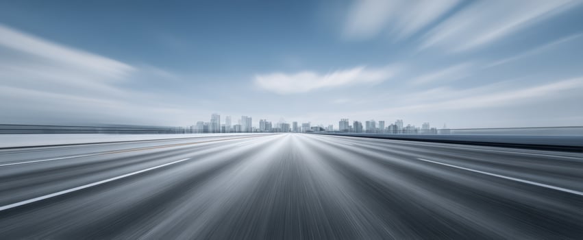 The exhilarating road leading to a vibrant city skyline in the distance photo