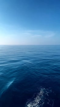 Calm Ocean Surface Under a Clear Blue Sky on a Serene Day by the Coast. photo