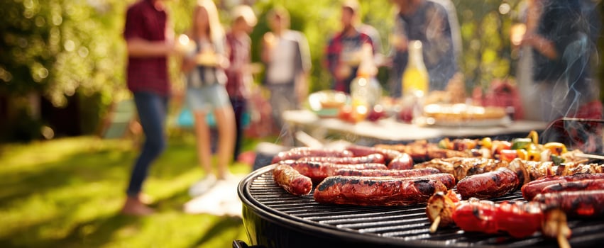 The vibrant barbecue scene featuring sausages sizzling on the grill. photo