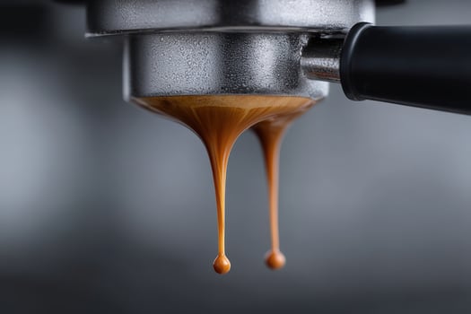 Espresso drips from coffee machine during brewing process in a cafe setting photo