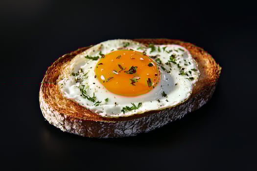 Freshly Cooked Fried Egg Served on Toasted Bread With Herbs and Spices for Breakfast photo