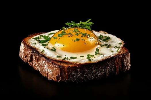 Delicious Toasted Bread Topped With Perfectly Cooked Sunny Side up Eggs and Fresh Herbs. photo
