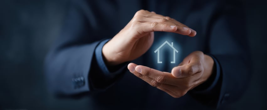 The Hands Holding a Digital Representation of a House for Protection and Investment photo