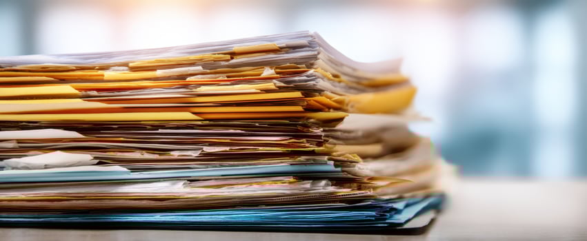 The Organized Chaos of Stacked Office Files and Documents photo