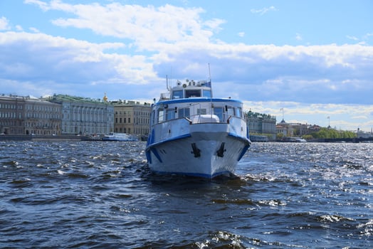 Enjoy a scenic riverboat ride on a sunny day in the vibrant city with stunning architecture photo