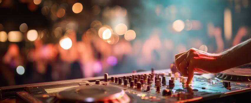 The DJ performing live with vibrant lights and an engaged audience. photo
