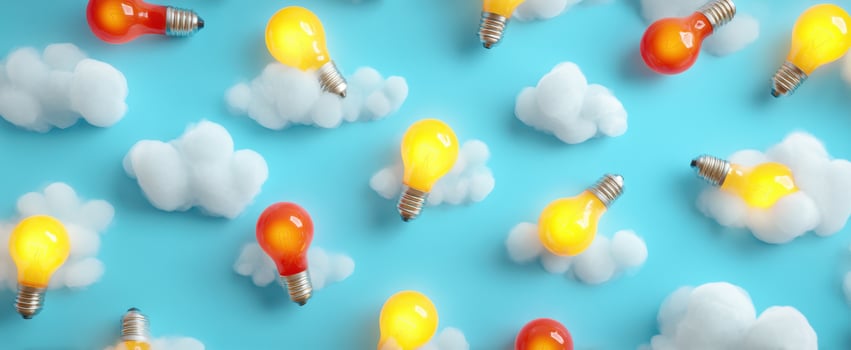 The Bright Lightbulbs Floating Among Fluffy Clouds in a Blue Sky photo