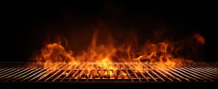 The grill igniting with vibrant flames ready for barbecue cooking. photo