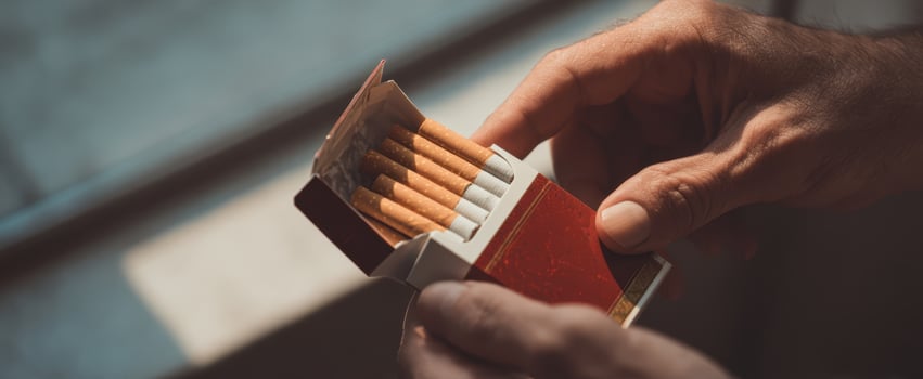 The Hands Holding an Open Cigarette Box in Soft Natural Light photo