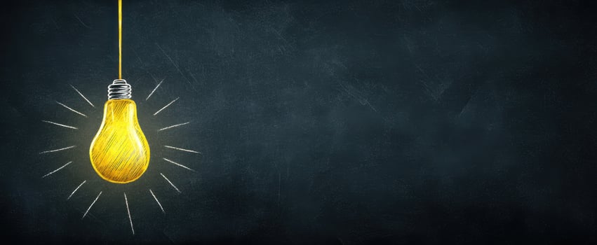The glowing light bulb symbolizes creativity and inspiration on a dark background. photo