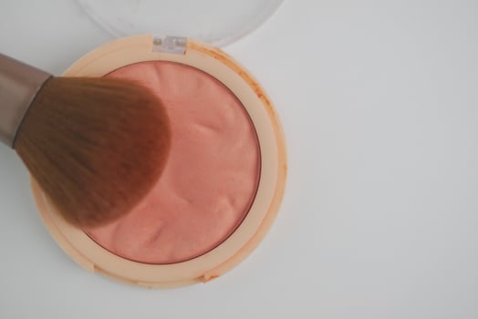 Blush application with brush on a smooth surface photo