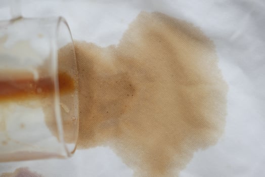 Coffee spills on white cloth surface in kitchen setting photo