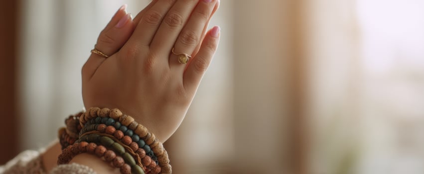 The elegant hands adorned with colorful bracelets in a serene setting. photo