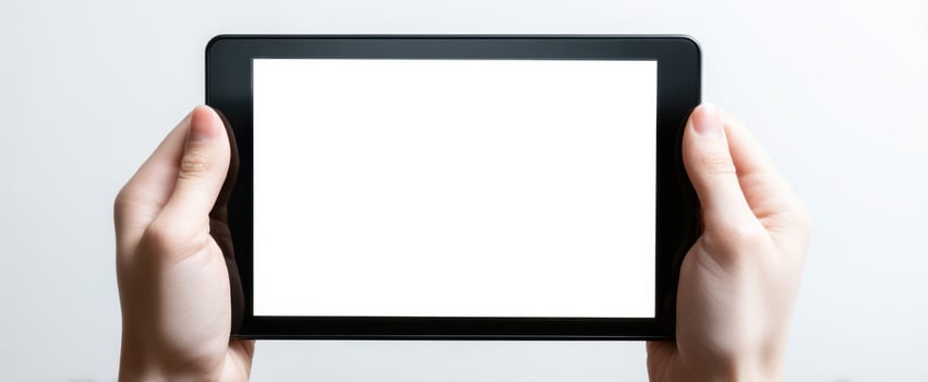 The tablet held in hands with a blank screen for design purposes. photo