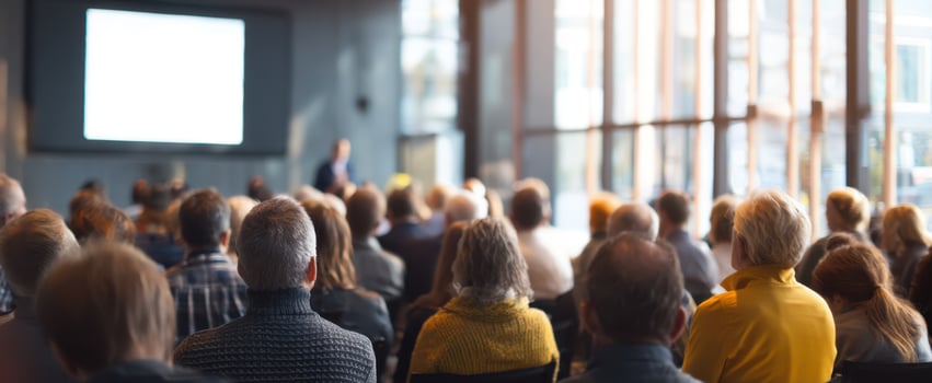 The engaged audience attending a professional seminar in a modern conference room. photo
