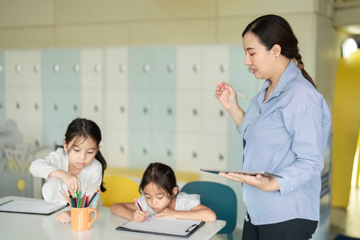 Back to School Creativity. Teacher guiding students in a colorful classroom. photo