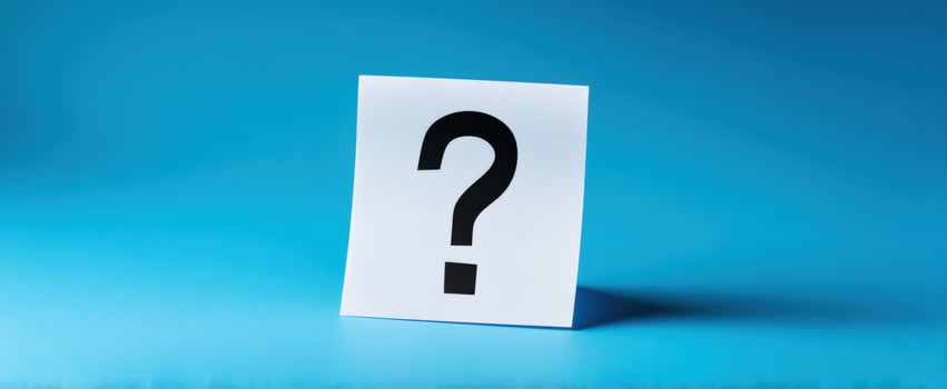 The question mark on a sticky note against a serene blue backdrop. photo