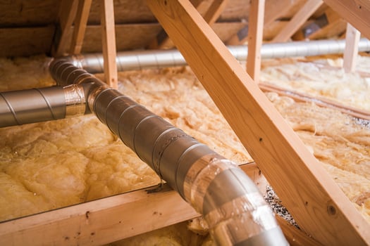 Ventilation Ducts Installed in Residential Attic With Insulation for Energy Efficiency During Winter Season photo