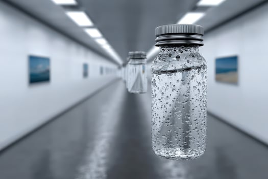 Exploration of lost sensations through a suspended bottle in a minimalist gallery photo