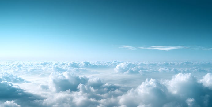 A mesmerizing view showcases fluffy white clouds nestled under a clear, bright blue sky photo
