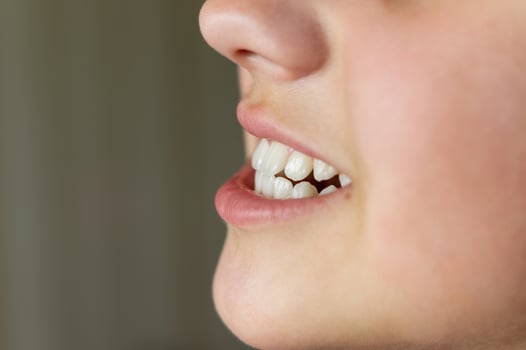 Even white healthy teeth of a child or person close-up side view photo
