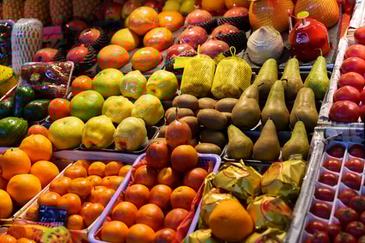 Colorful variety of fresh fruits displayed at a market in the evening light photo