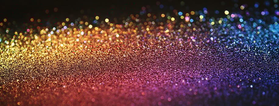 Bright defocused lights cascade over a textured surface shifting smoothly from orange to blue hues photo