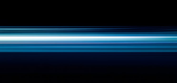 Dynamic streaks of blue and white light illuminate the deep black background vibrantly photo