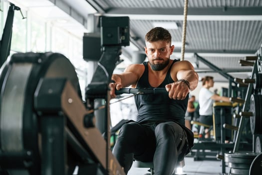 Exercise for stamina.. Strong muscular man is working out in the gym photo