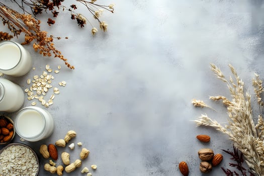 Jars brimming with nondairy milk alongside oats, almonds, peanuts, walnuts create a beautiful composition photo